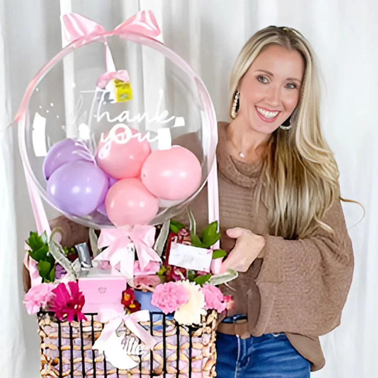 Joyfull Balloon Boutique creator holding a personalized stuffed balloon gift